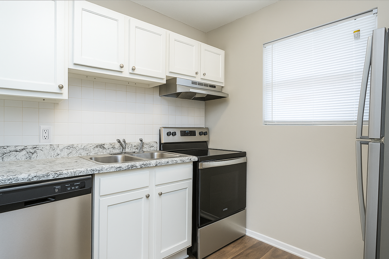 Kitchen with white cabinets, stainless steel appliances, and a window with blinds.