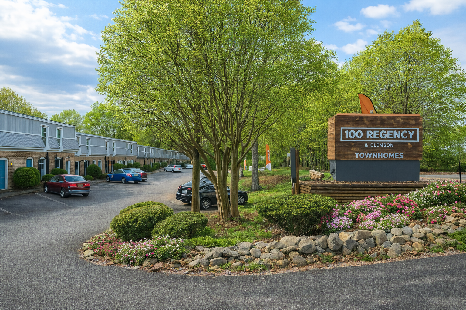 100 Regency Inn sign with cars, bushes, and motel rooms in a tree-lined setting.