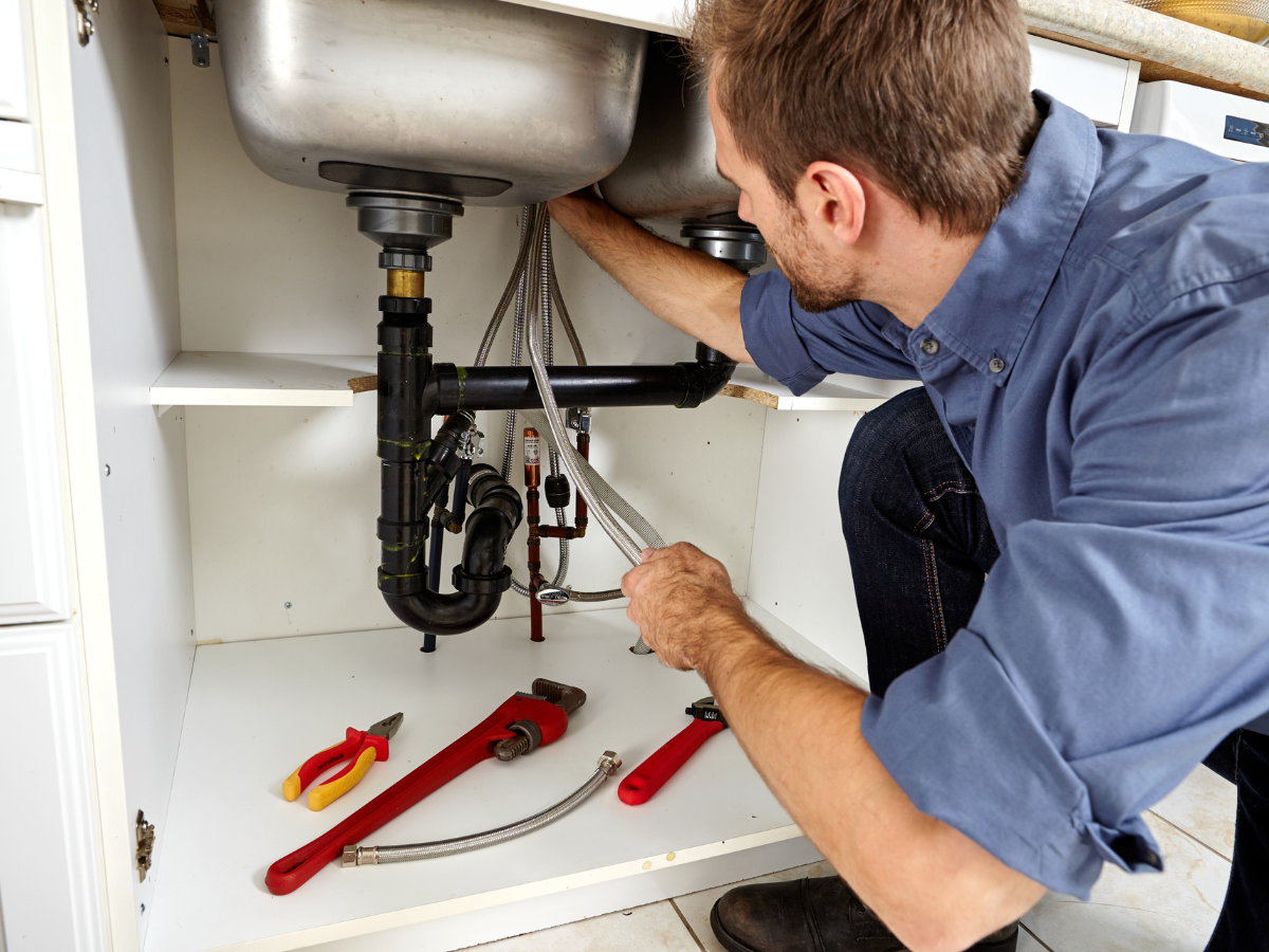 A plumber checking the pipes