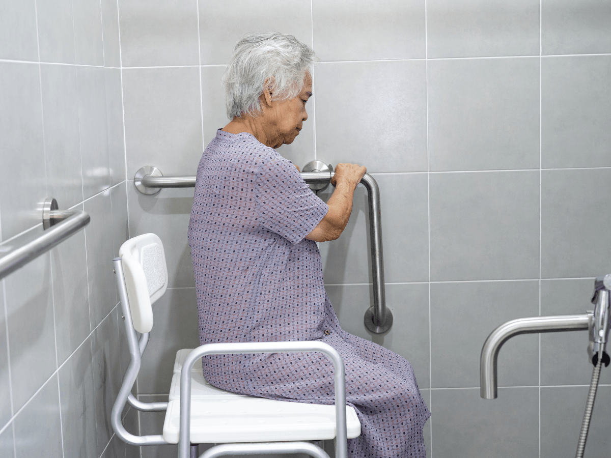 a elderly holding on a support rail