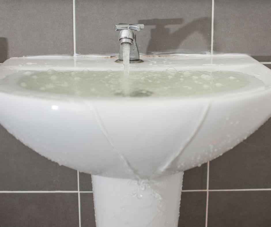 One of the signs of a blocked sewer is the clogged bathroom sink drain.