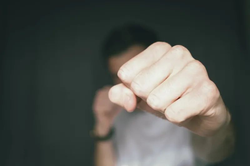 A man is holding his fist up in the air.