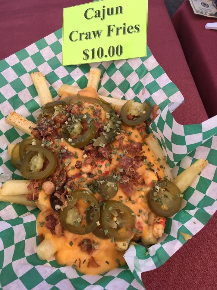 Cajun crawfish fries with cheese, jalapeños, and seasoning, served in a checkered basket.