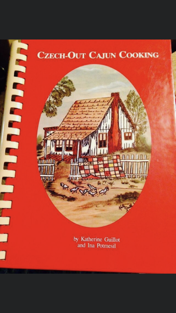 Fried chicken bites and fries on checkered paper with pickle.