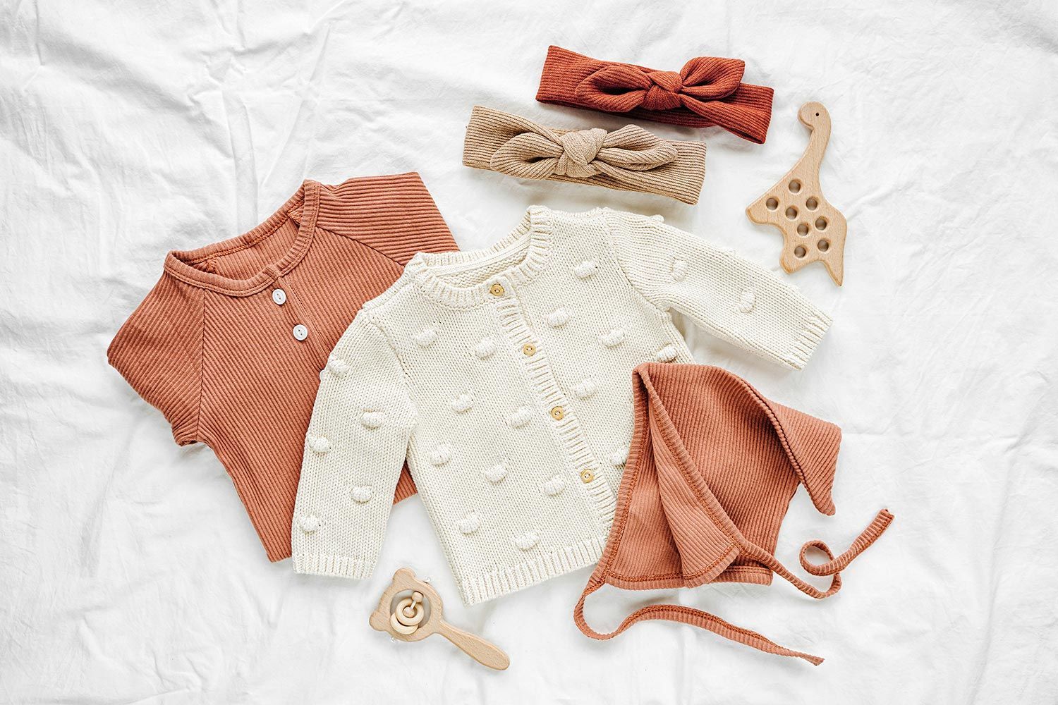 Baby clothes on bed