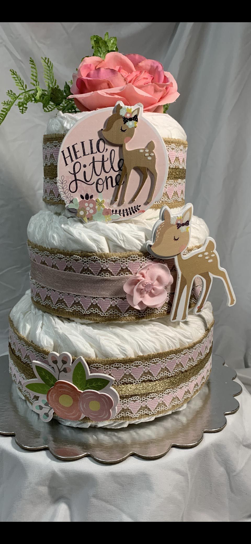 Three-tiered diaper cake with deer and floral decorations