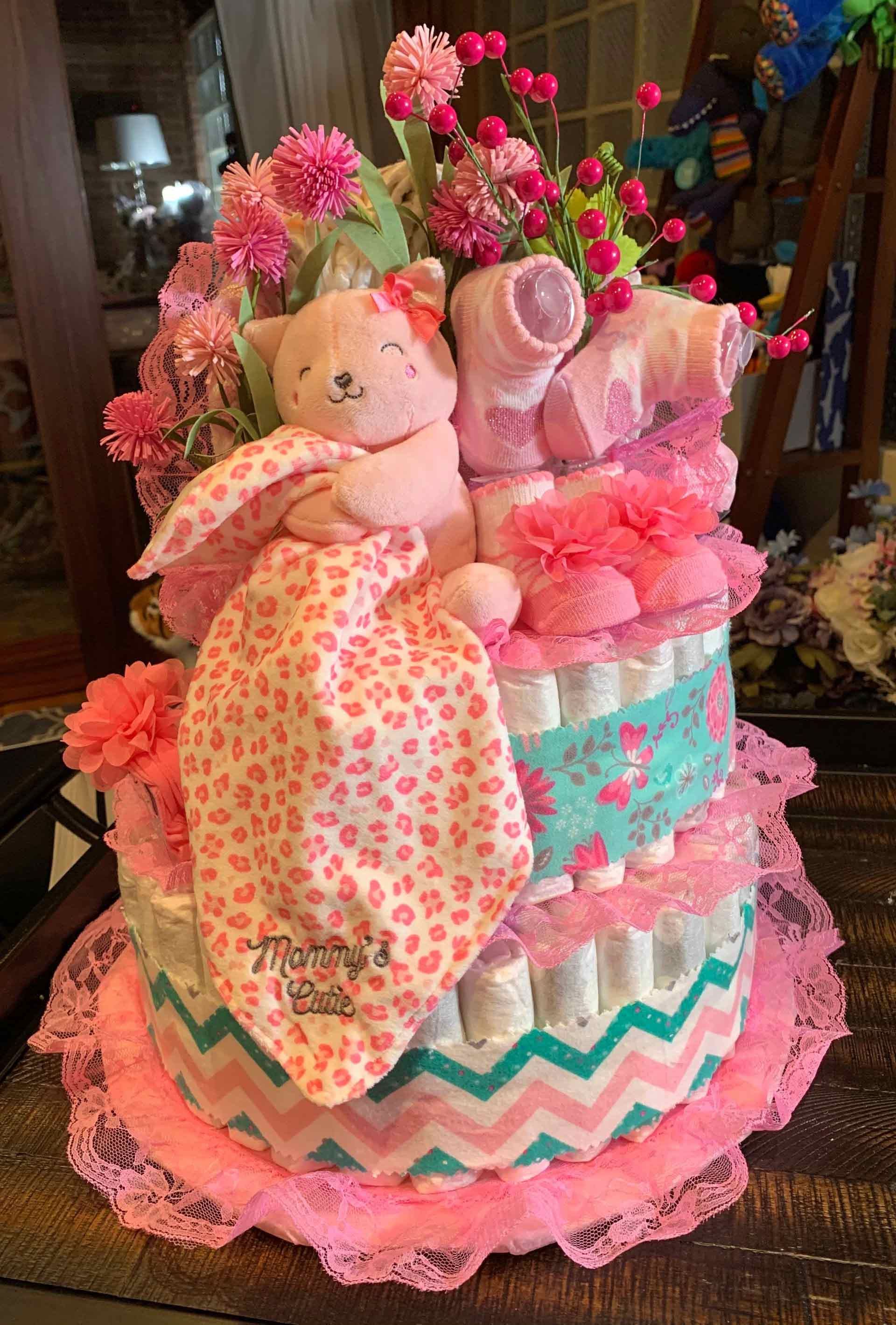 Pink diaper cake with a teddy bear