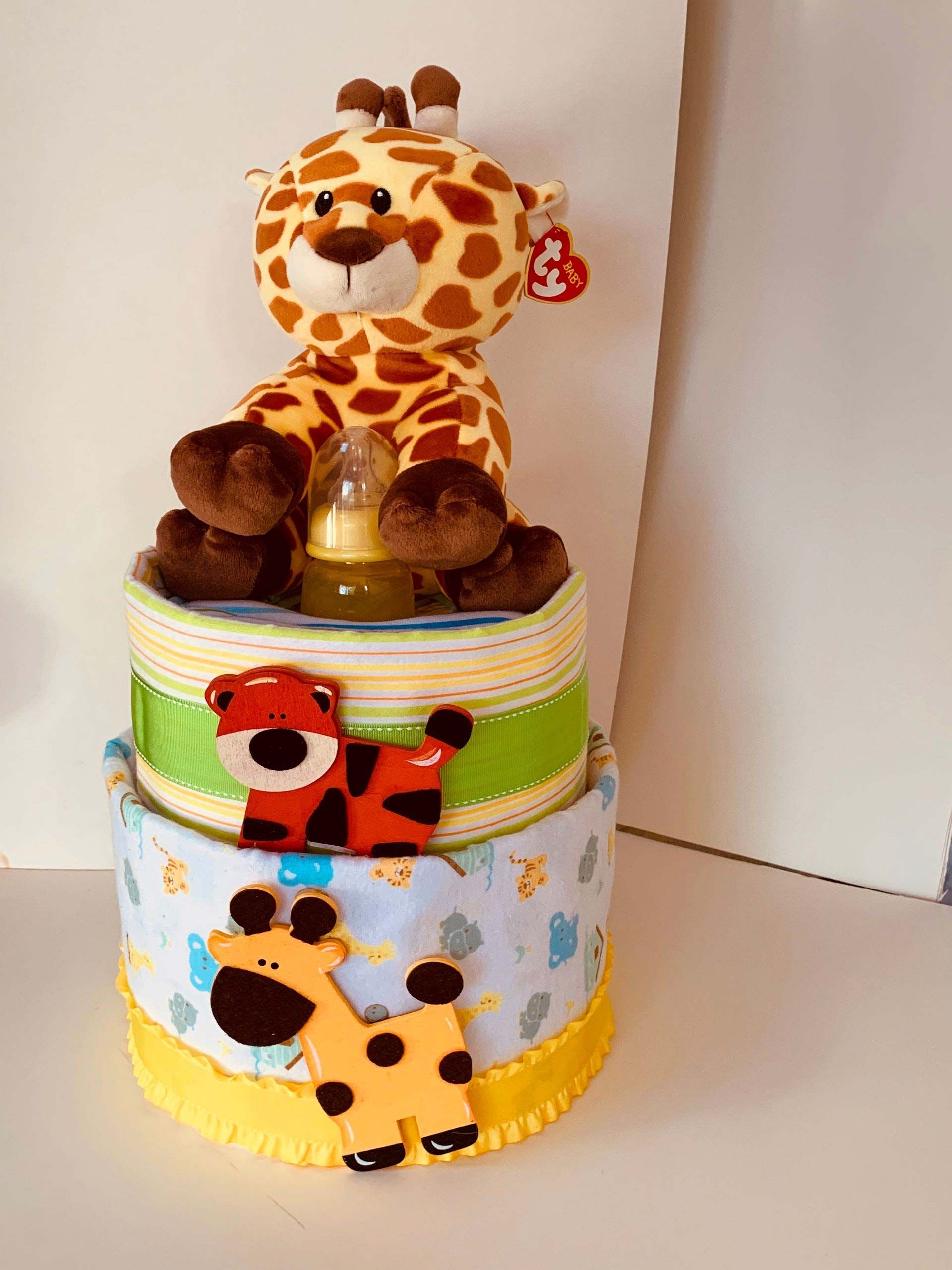 Diaper cake with stuffed giraffe and animal decorations