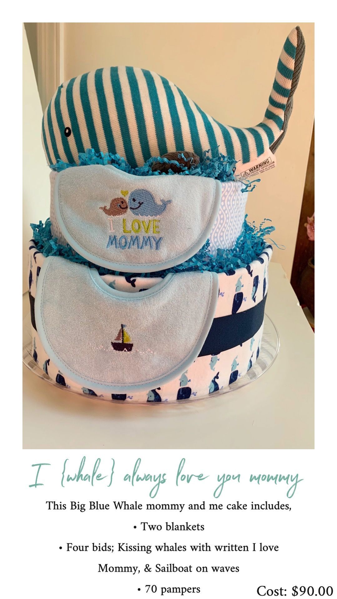 Baby shower diaper cake with whale topper and bibs