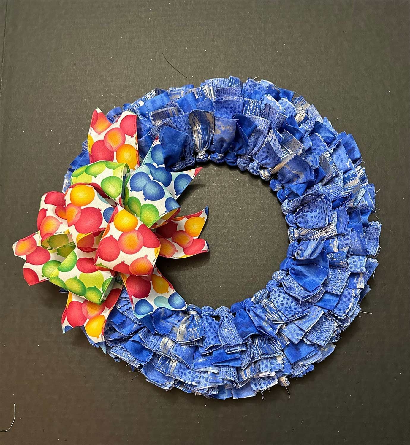 Blue fabric wreath with a colorful bow