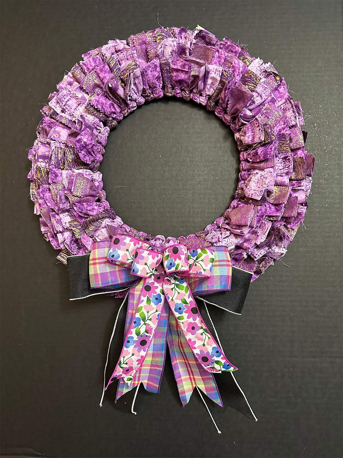 Purple fabric wreath with floral bow