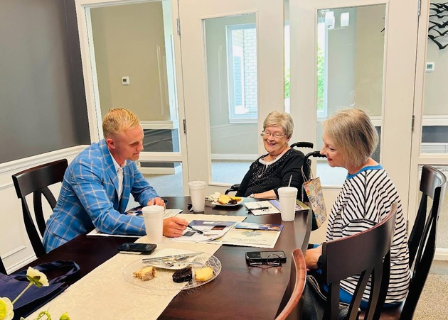 Staff Member shaking hands greeting couple at Hillside