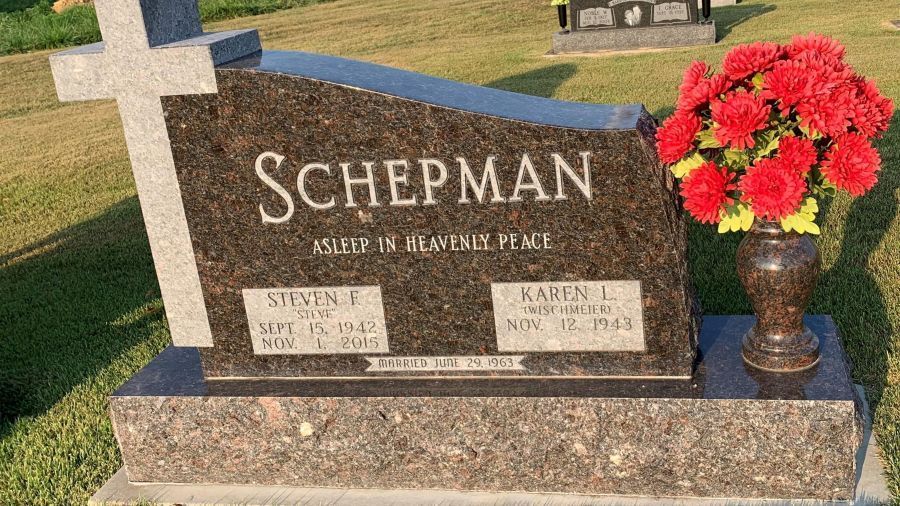 A large white house with a handicapped parking spot in front of it.