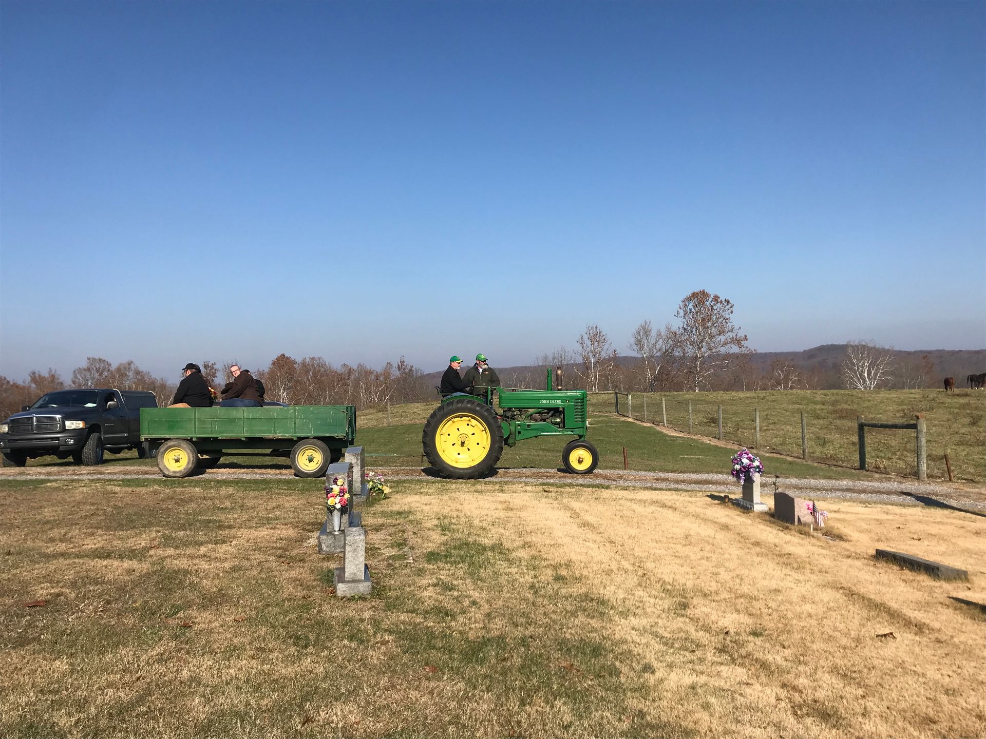 A brick building with a lot of windows is sitting on the side of the road.