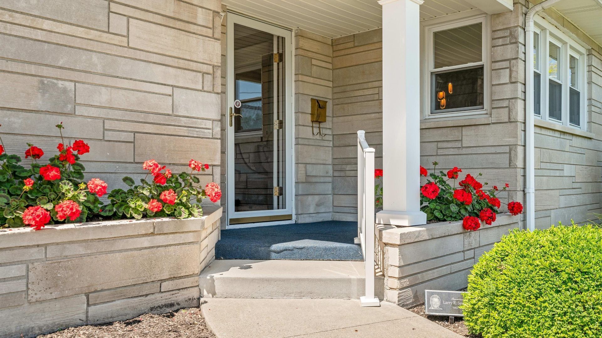 A large white house with a handicapped parking spot in front of it.
