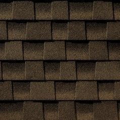 A close up of a row of brown shingles on a roof.