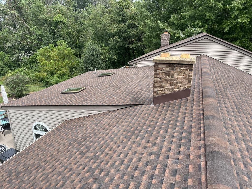 The roof of a house with a chimney on top of it.