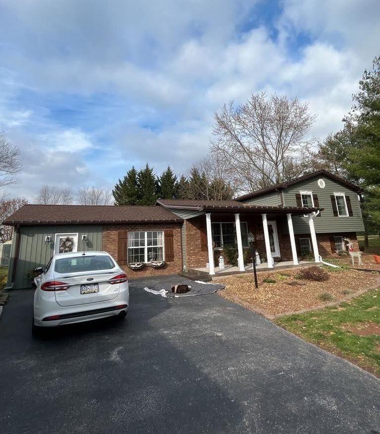 A white car is parked in front of a house