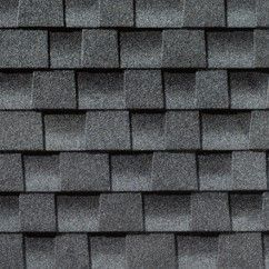 A close up of a row of gray shingles on a roof.