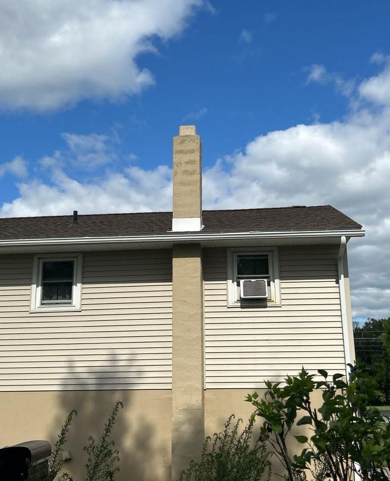 A house with a chimney on the side of it