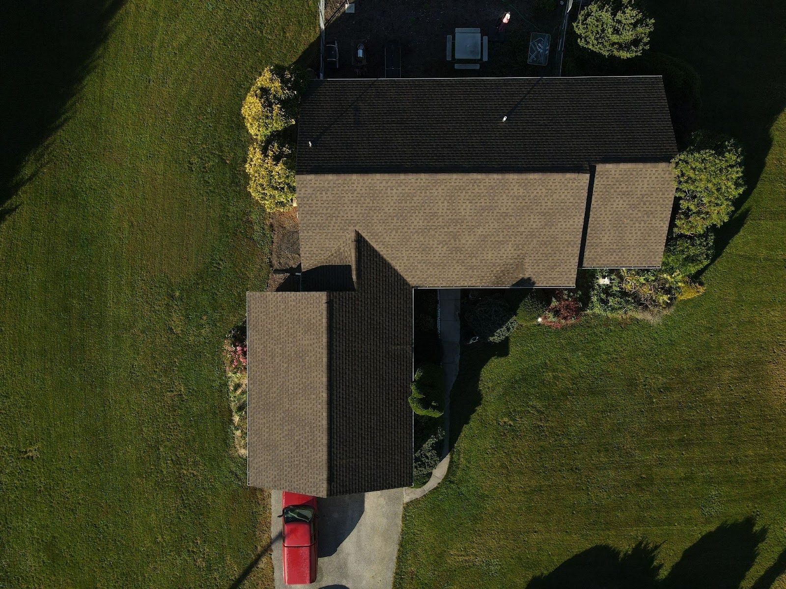 An aerial view of a house with a red truck parked in front of it.
