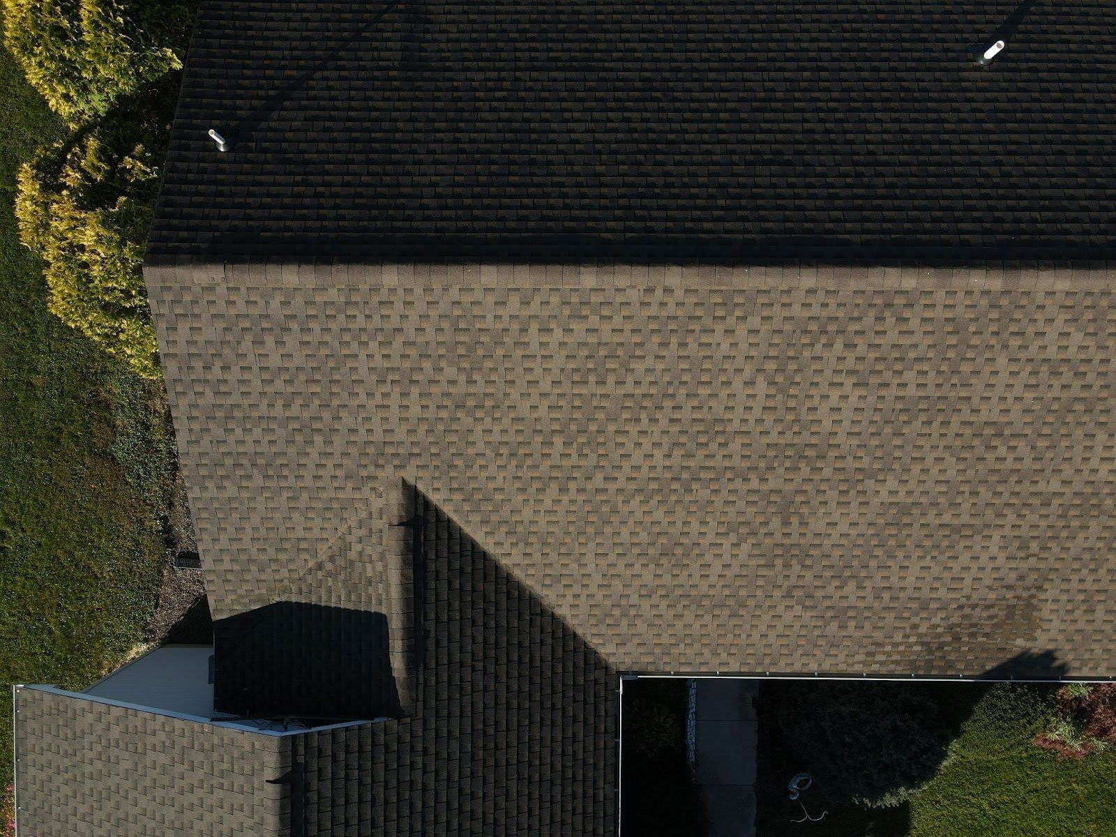 An aerial view of a house with a roof and a garage.