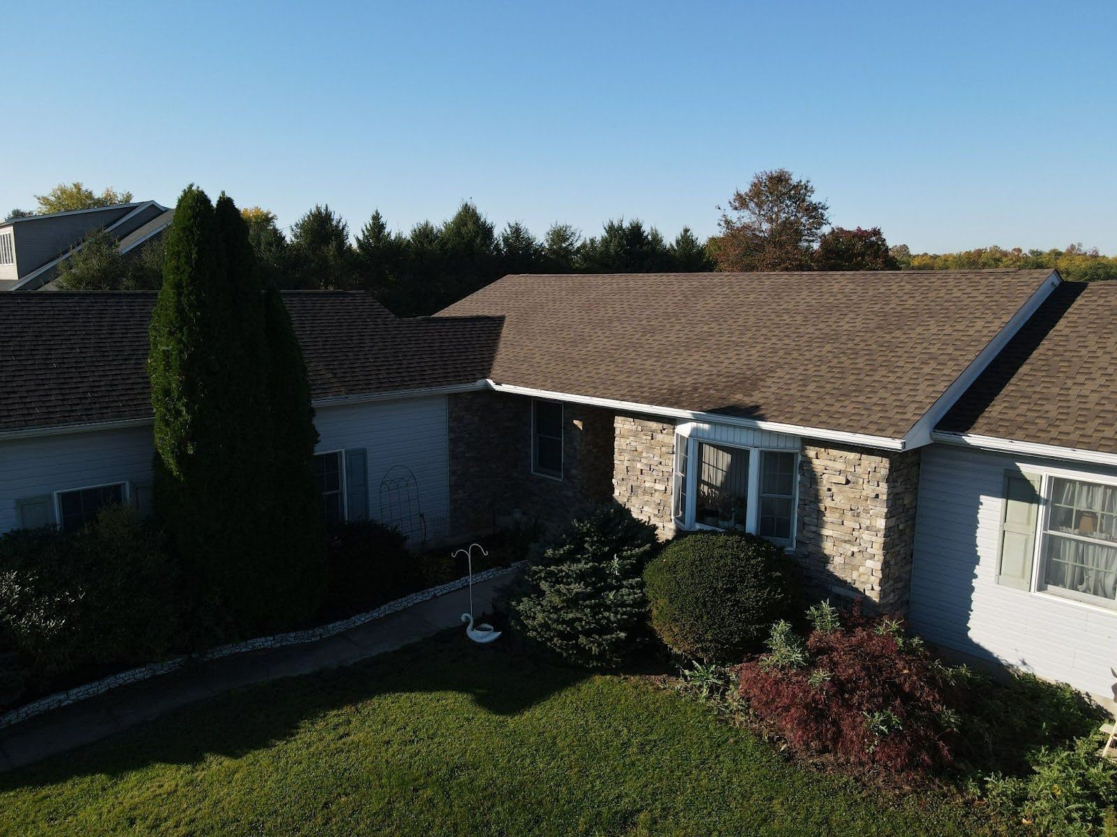 An aerial view of a house with a brown roof
