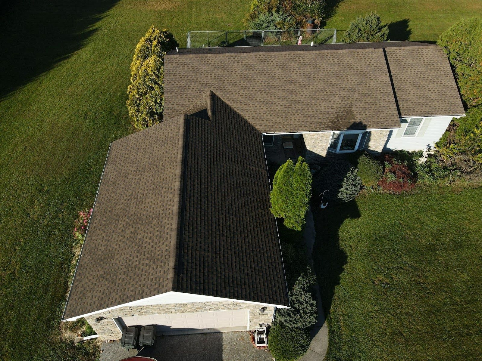 An aerial view of a house with a brown roof