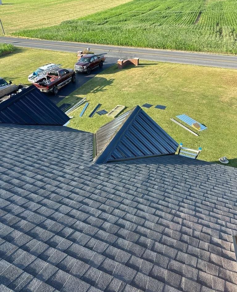 A car is parked on the side of the road next to a roof.