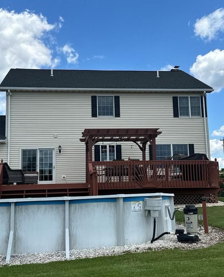 The back of a house with a pool and a deck