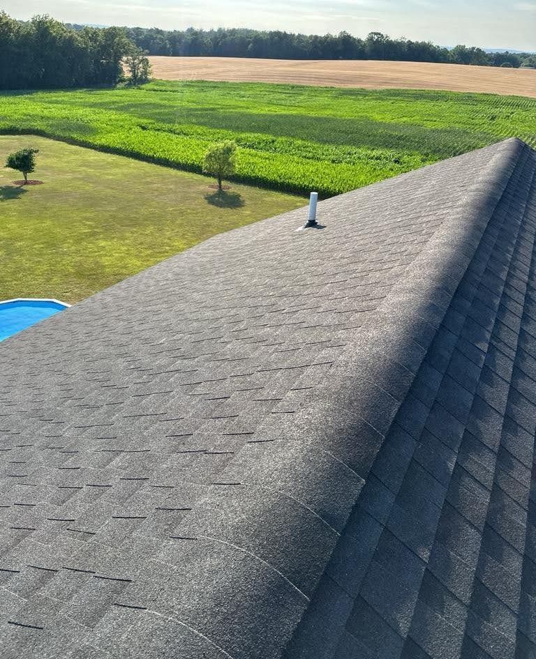 A roof with a view of a field and a pool