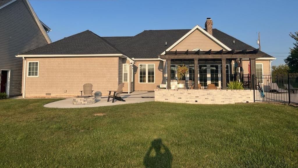 A large house with a large lawn in front of it.