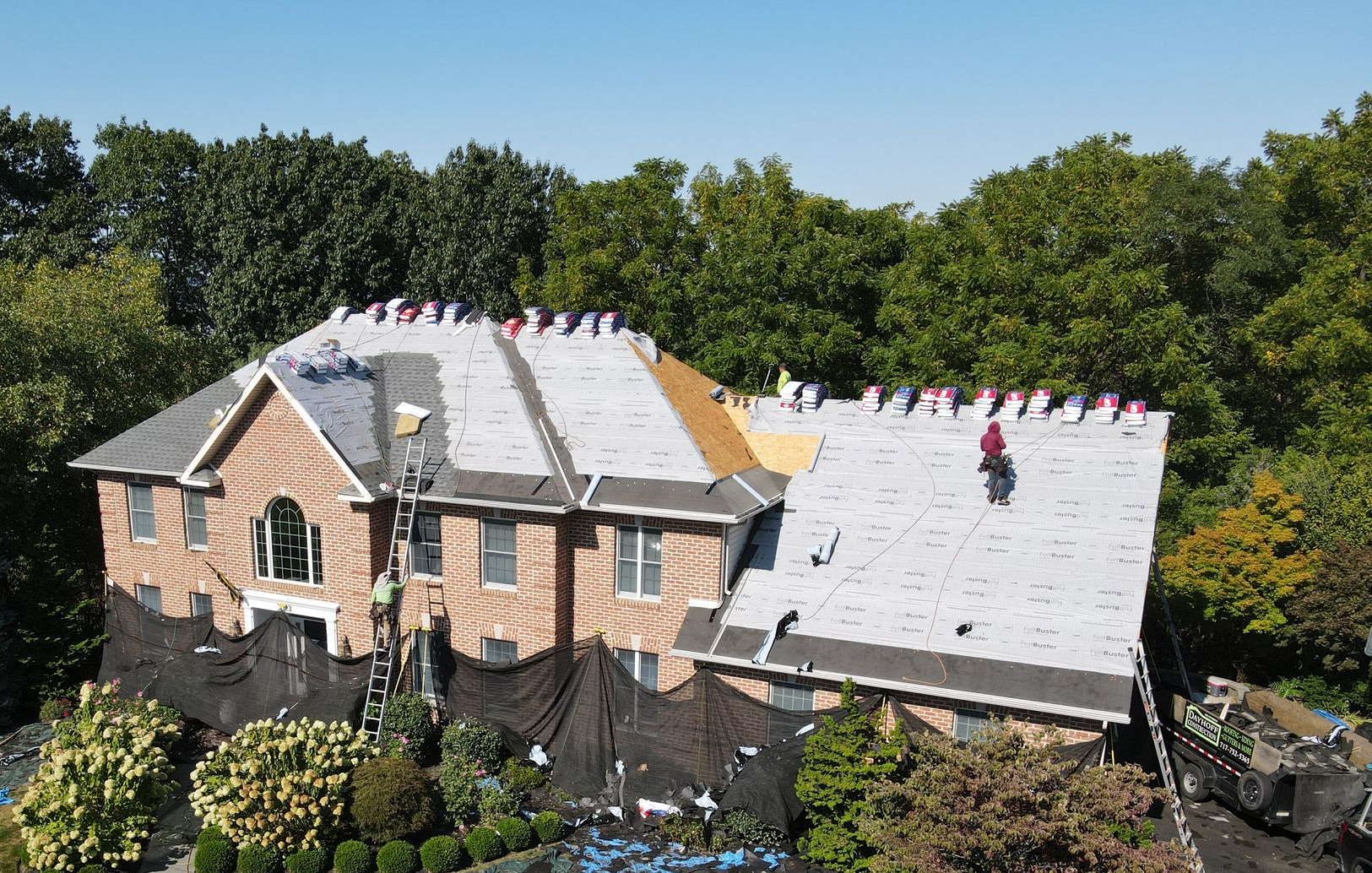 A large house having their roof replaced by Dayhoff Construction.