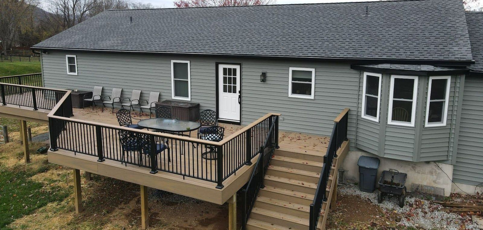 An aerial view of a house with a large deck.