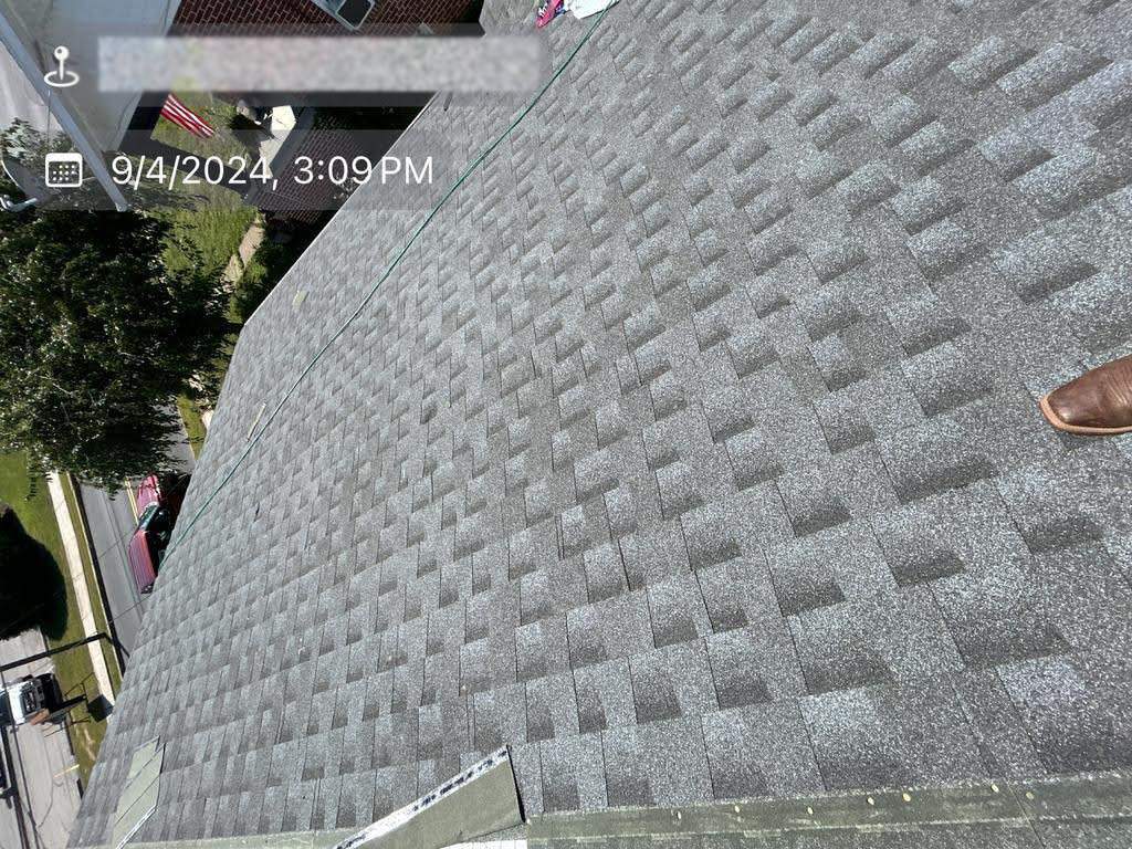 A person is standing on the roof of a house.