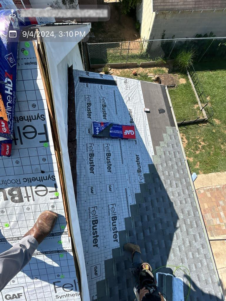 An aerial view of a roof being installed on a house.