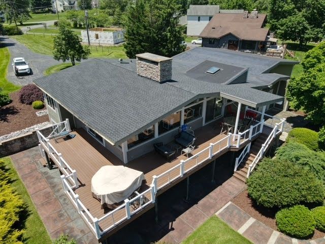 An aerial view of a house with a large deck