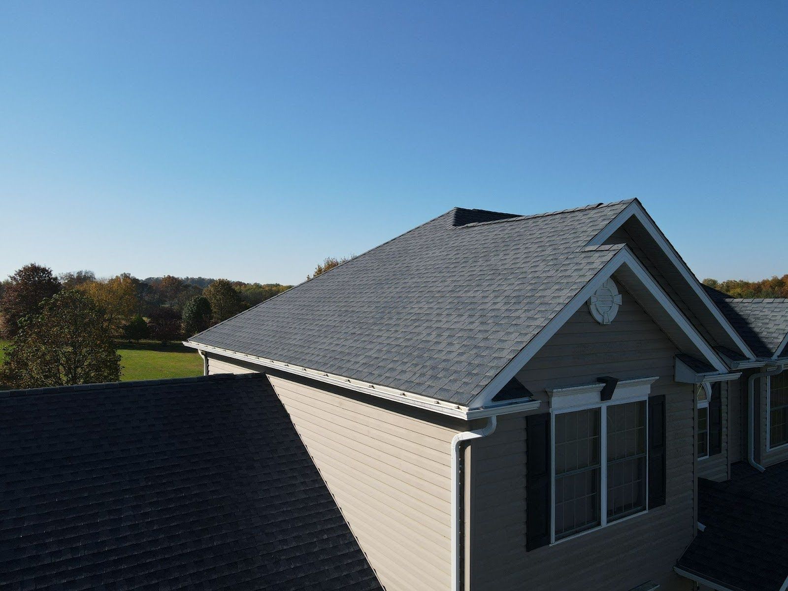 An aerial view of a house with a gray roof