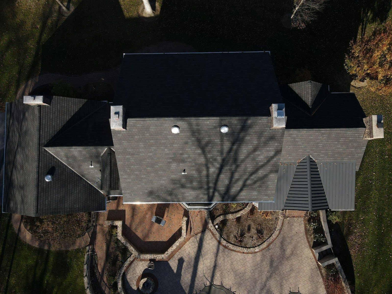 An aerial view of a house with a black roof