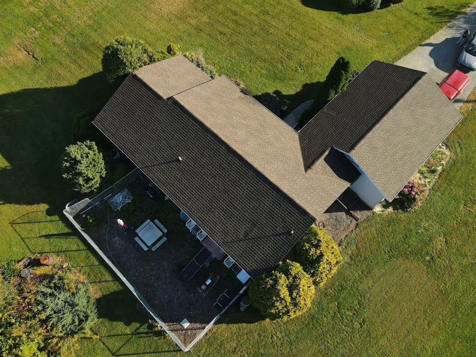 An aerial view of a house with a roof and a deck.