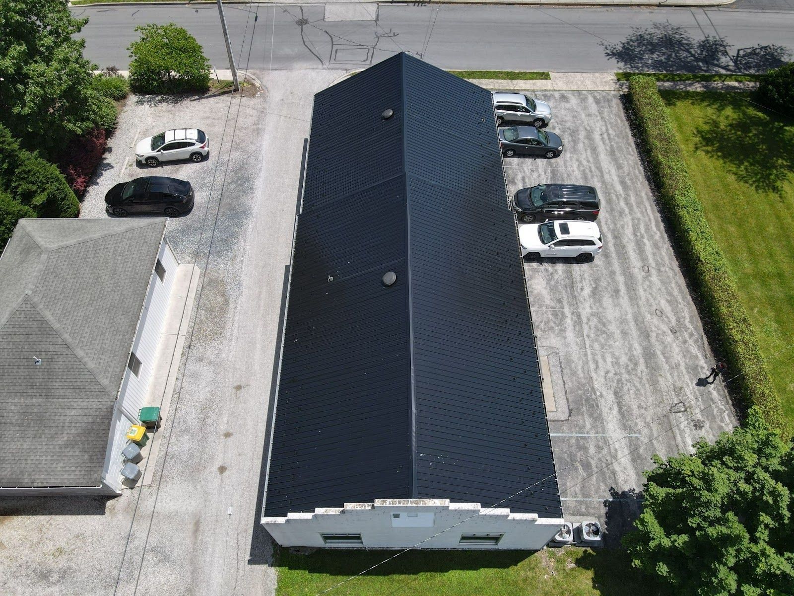 An aerial view of a building with cars parked in front of it