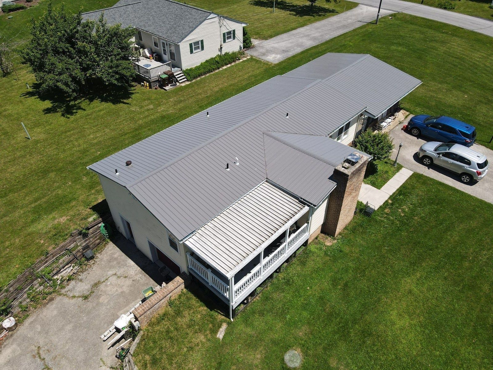 An aerial view of a house with a gray roof.