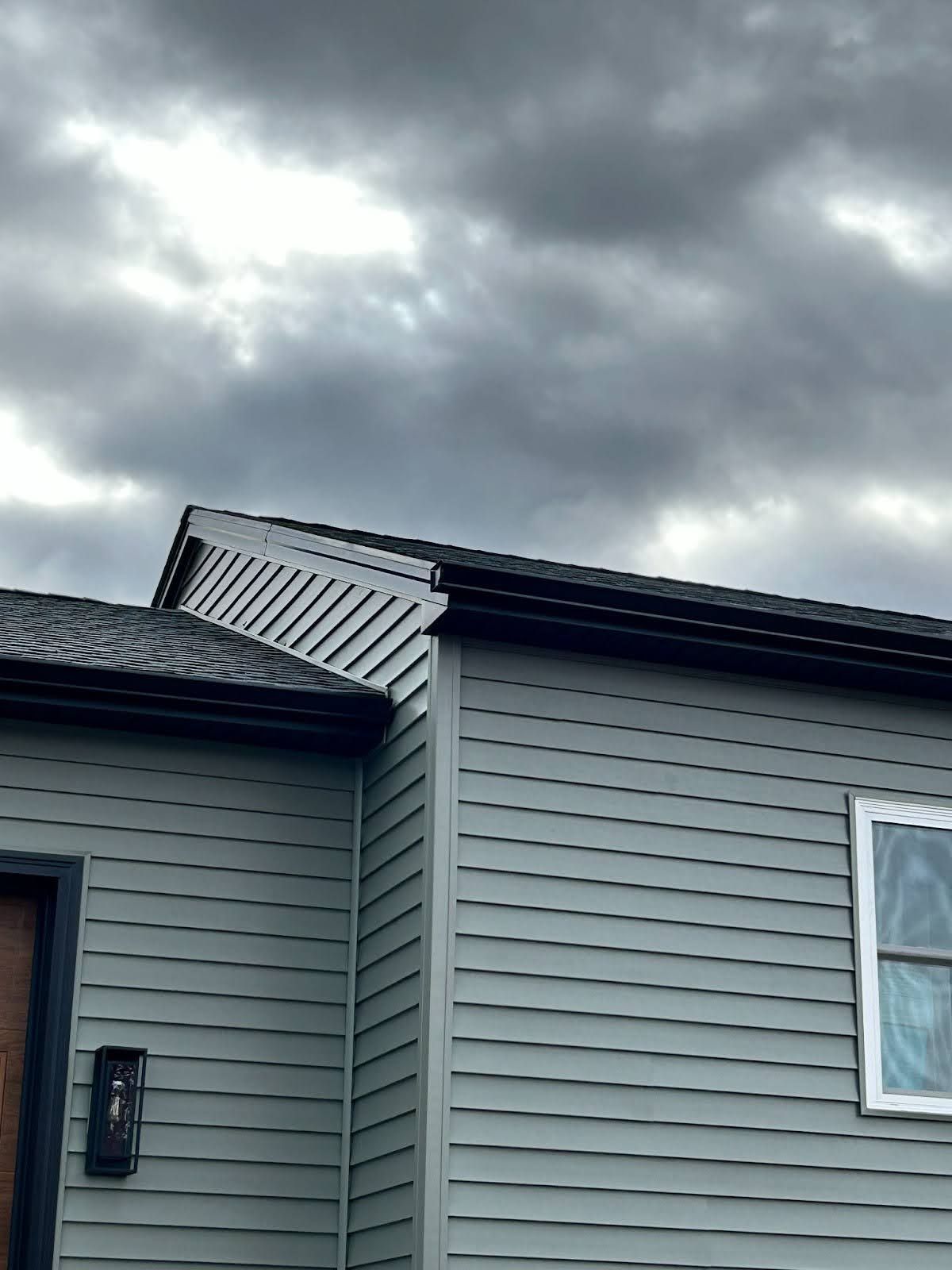 A house with a cloudy sky in the background.