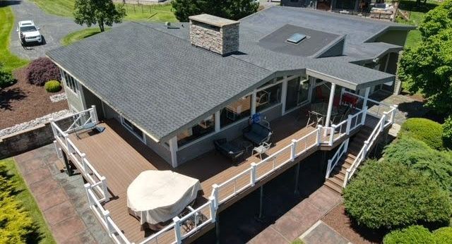 An aerial view of a house with a large deck.