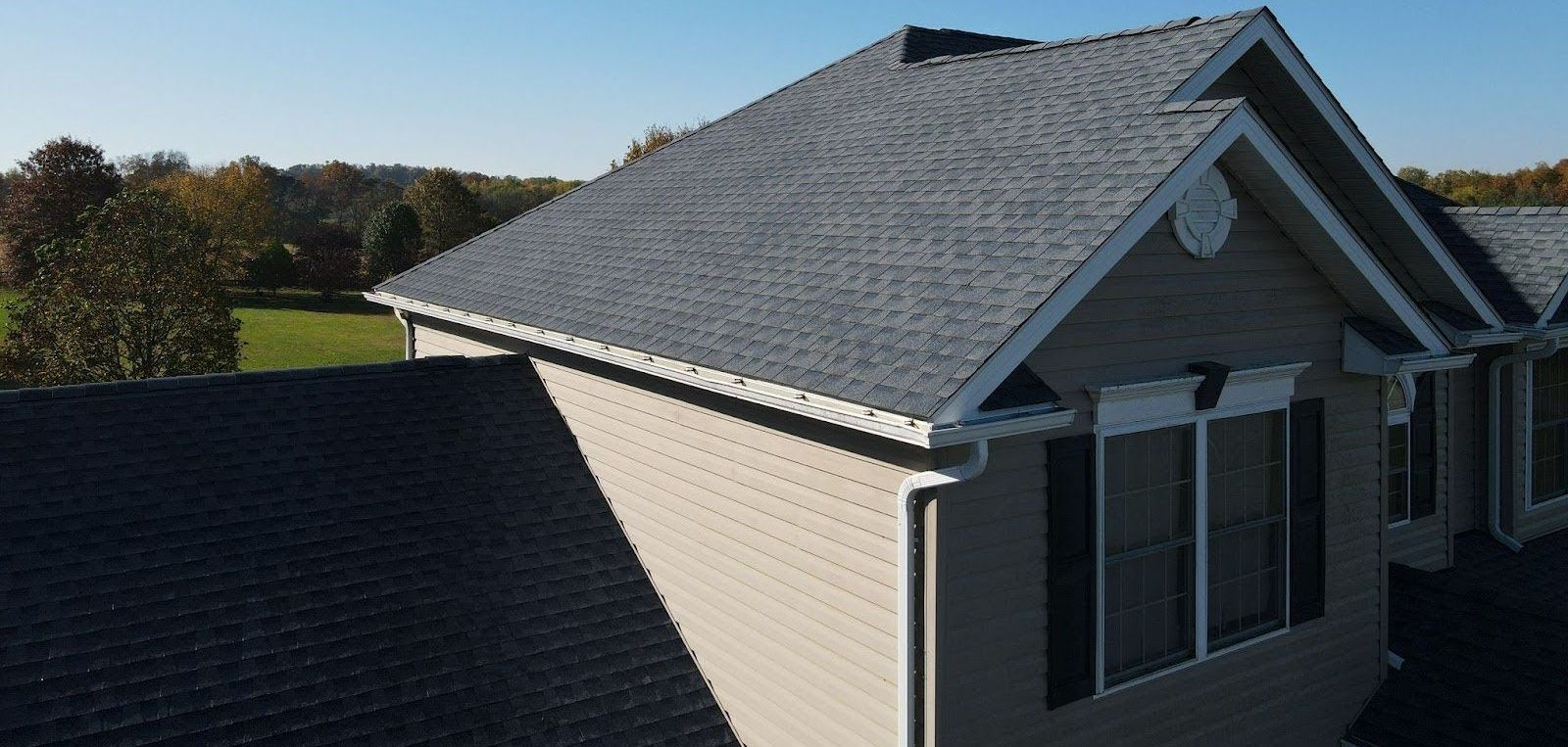 An aerial view of a house with a gray roof.