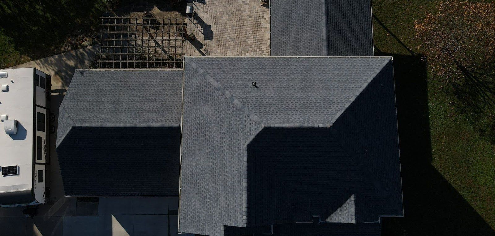An aerial view of a house with a gray roof.