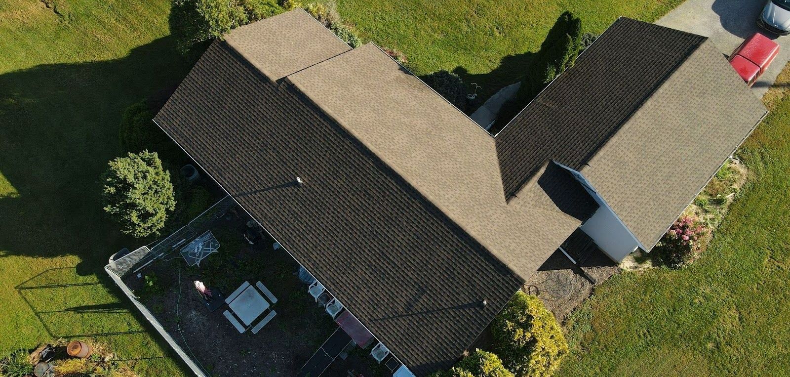 An aerial view of a house with a car parked in front of it.
