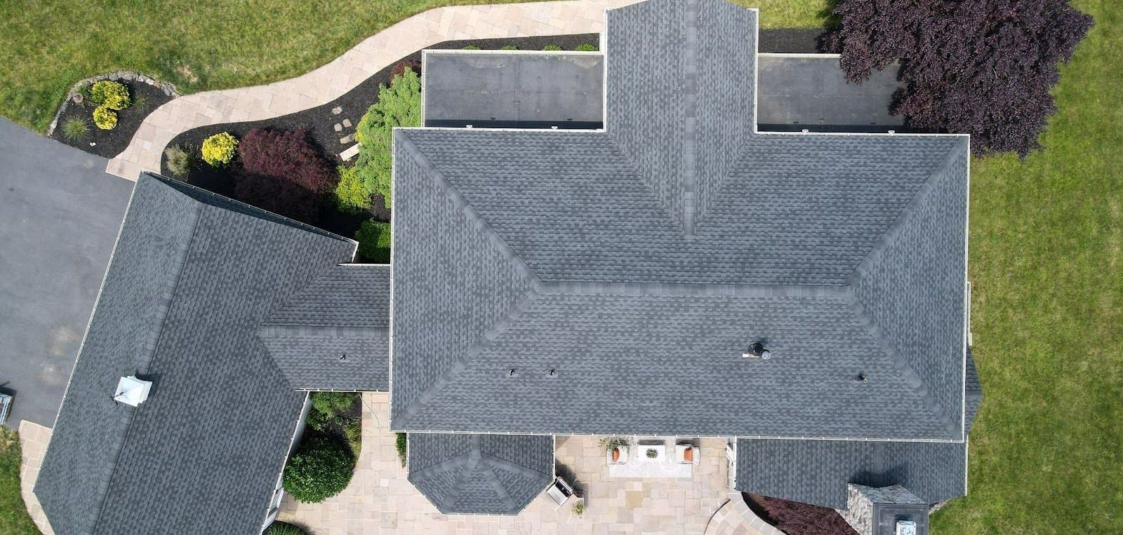 An aerial view of a large house with a roof.