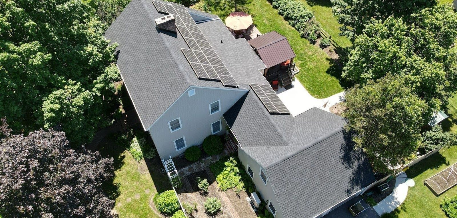 An aerial view of a large house surrounded by trees