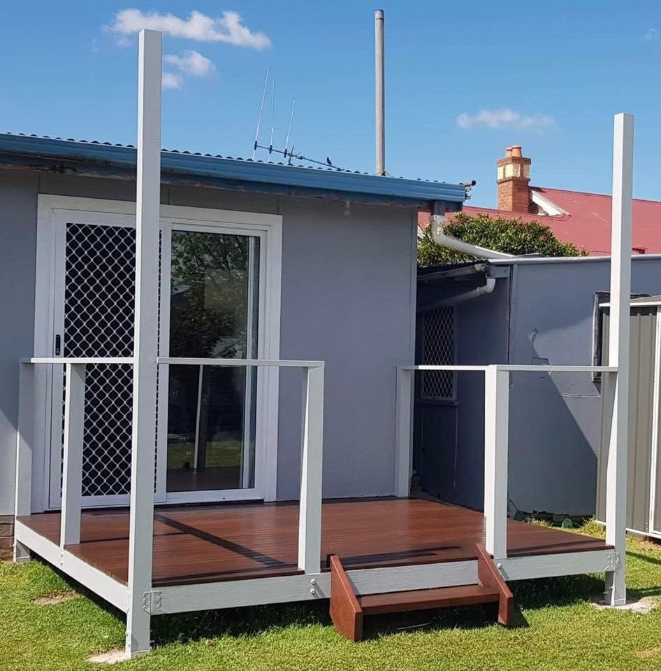 A White House With a Large Porch and a Wooden Deck — JKD Pest & Carpentry In Wellington, NSW